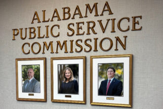 Photos of current Alabama Public Service Commissioners hang in the PSC offices. Chris Beeker (right) lost his reelection bid against Republican opponent Jim Zeigler. Credit: Dennis Pillion/Inside Climate News