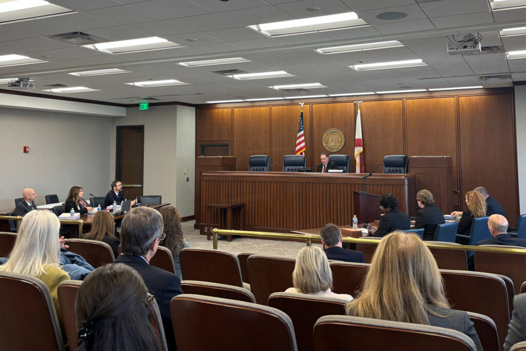The Alabama Public Service Commission hosts an informal hearing to discuss Alabama Power’s yearly returns on Dec. 9. Administrative Law Judge John Garner presides over the hearing as two commissioners sit in the audience. Credit: Dennis Pillion/Inside Climate News