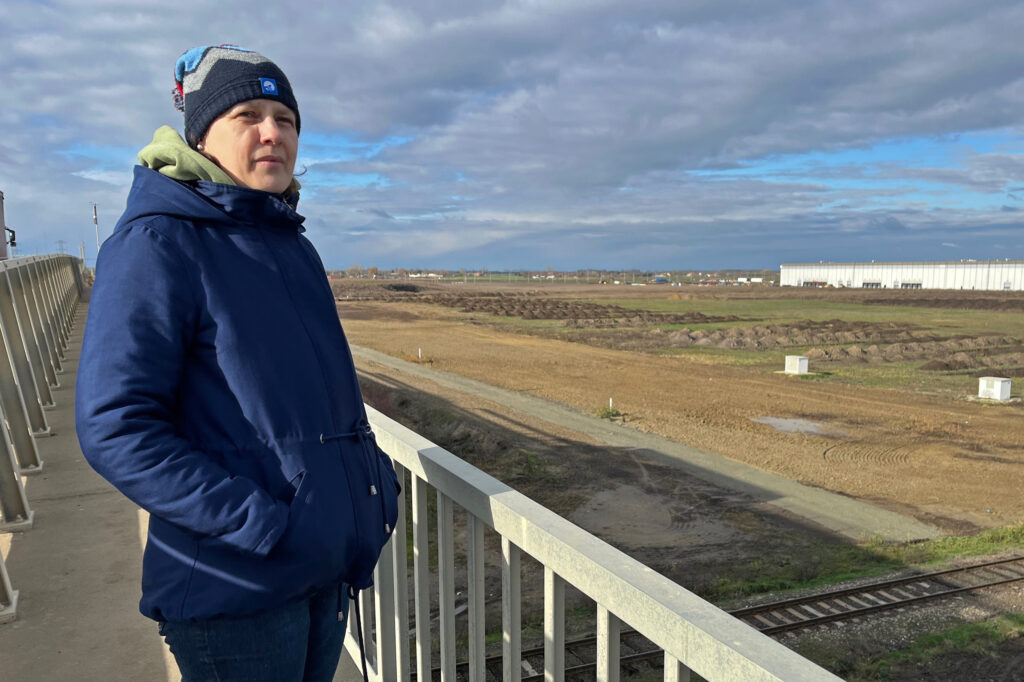 Éva Kozma looks out over the industrial park that houses Debrecen’s cluster of battery factories. Credit: Nicholas Kusnetz/Inside Climate News