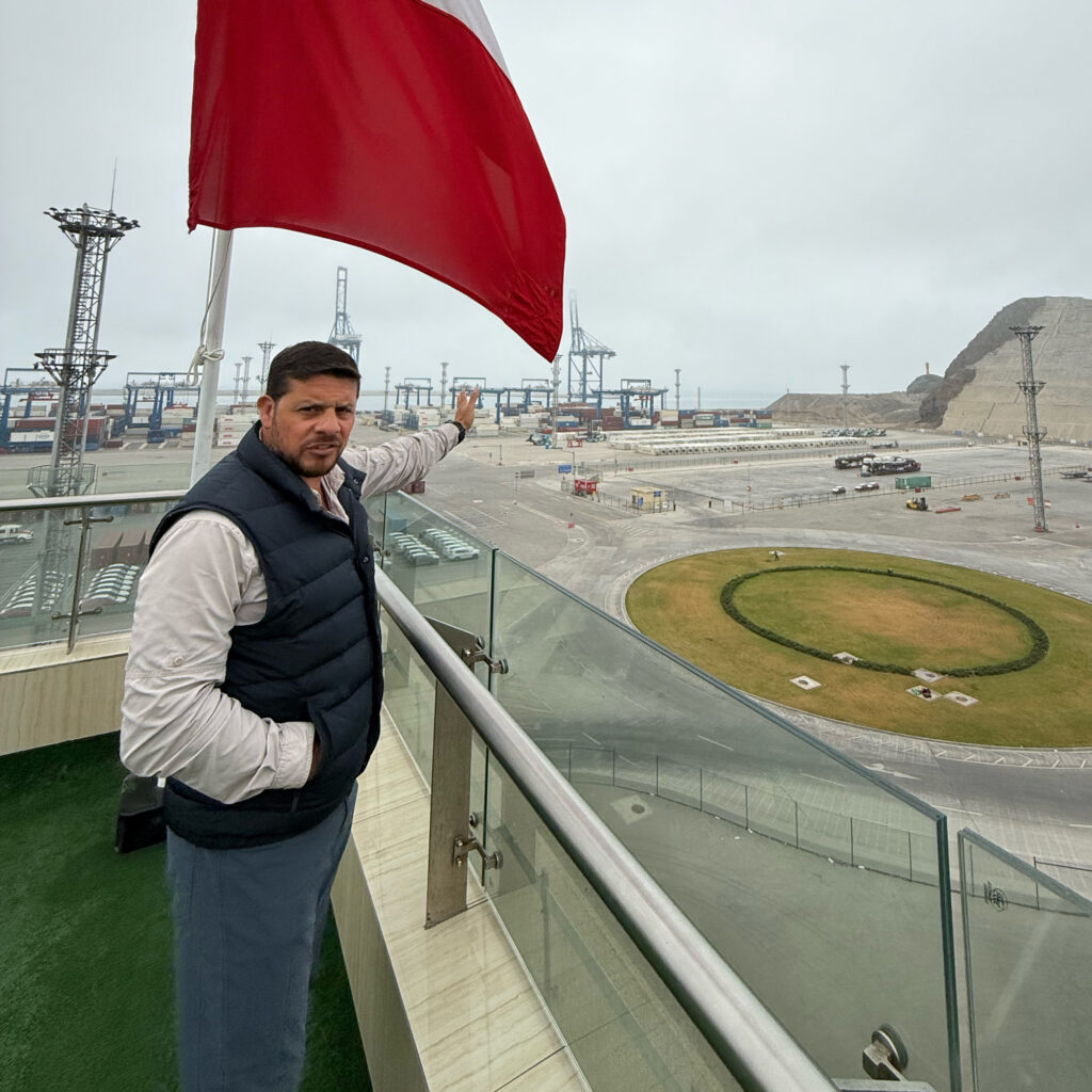 Jason Guillén Flores, the Chancay port’s safety and environment manager, points toward the port’s cranes, which are remote-controlled from an operations center. Credit: Georgina Gustin/Inside Climate News