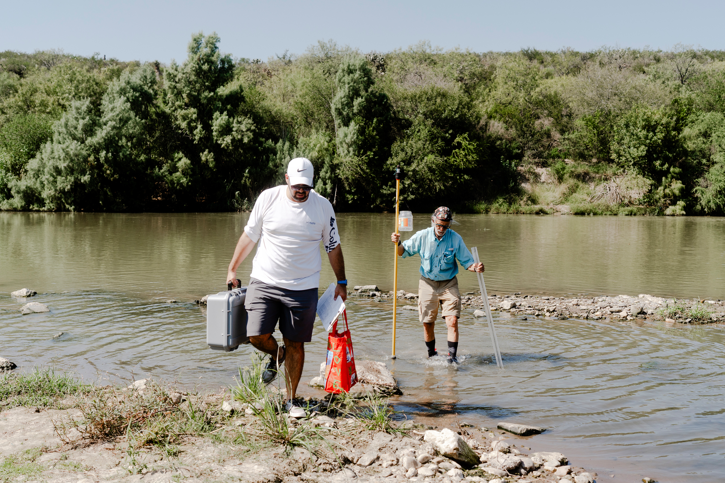 Martin Castro (left) and Tom Vaughan collect water samples in the Rio Grande on October 28.