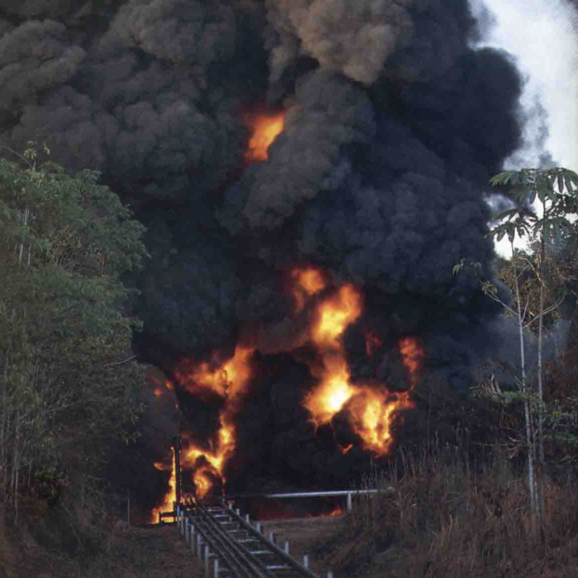 An open fire at a waste pit in Cuyabeno Wildlife Preserve in the Ecuadorian Amazon rainforest. Photo originally published in Kimerling’s “Amazon Crude.”
