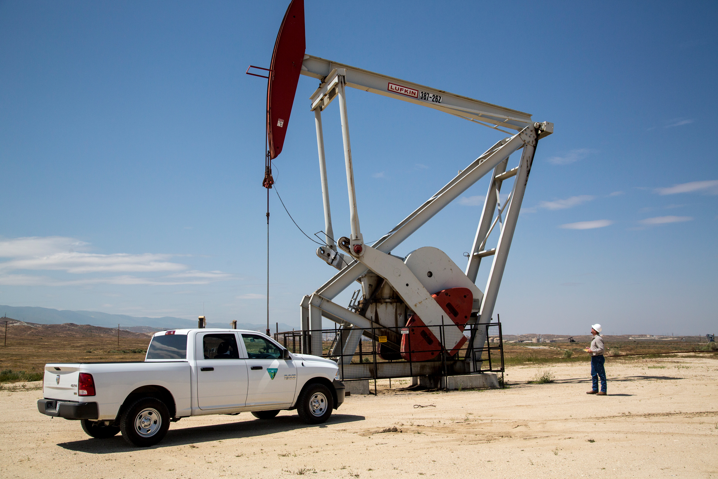 A BLM employee inspects an oil pumpjack in Kern County, California. Credit: Bob Wick/BLM