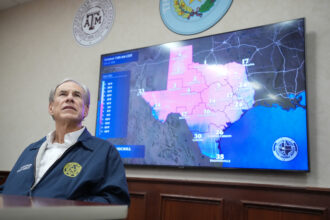 Texas Gov. Greg Abbott listens to a briefing as he prepares for a winter storm at the State Operations Center in Austin. Credit: Jay Janner/The Austin American-Statesman via Getty Images