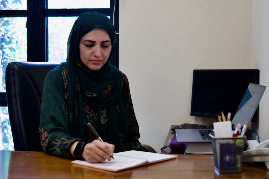 Ayesha Ali, associate professor at the Lahore University of Management Sciences, works in her Lahore office. Credit: Aman Azhar/Inside Climate News