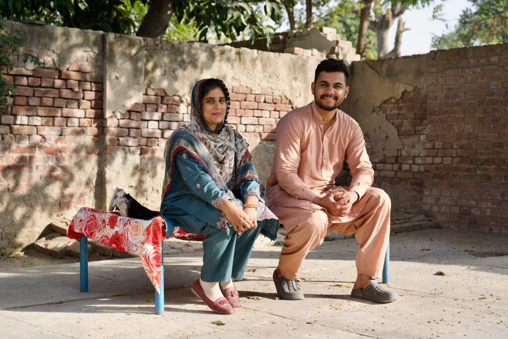 Muhammad Imran and his wife, Asma Rafique, sit in the courtyard of their home in Qadirabad near the Sahiwal coal power plant. Credit: Aman Azhar/Inside Climate News