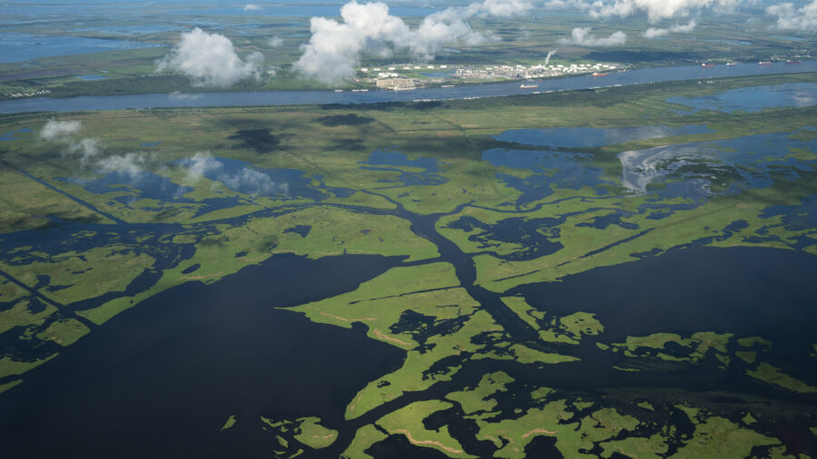 Coastal waters flow through deteriorating wetlands in Plaquemines Parish, Louisiana. Since the 1930s, Louisiana has lost over 2,000 square miles of land, an area roughly the size of Delaware, partially due to climate-driven sea level rise. Credit: Drew Angerer/Getty Images