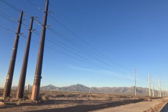 Transmission lines along Stan Roberts Sr. Avenue in Northeast El Paso, adjacent to the construction site of the Meta data center. The Franklin Mountains are visible in the background. Credit: Martha Pskowski/Inside Climate News