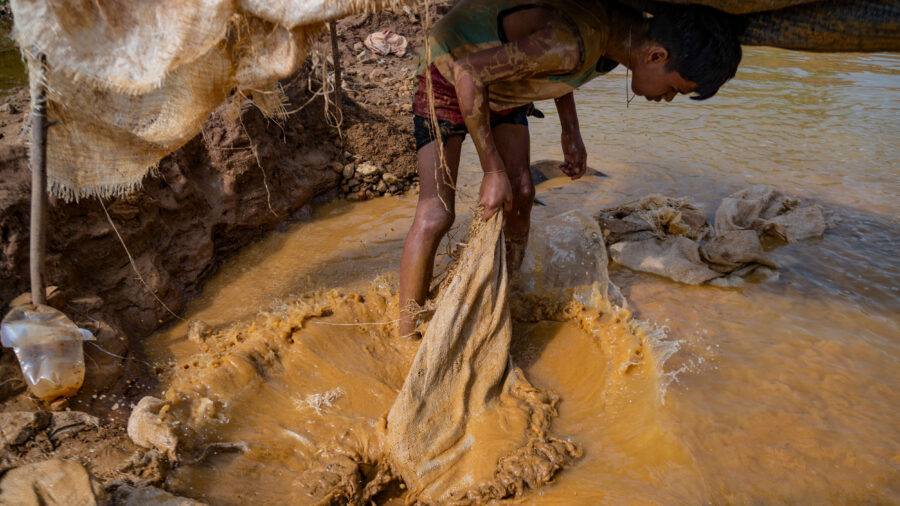 A young Venezuelan miner works in an open pit mine in search of gold in El Callao, Venezuela, on Aug. 29, 2023. Credit: Magda Gibelli/AFP via Getty Images