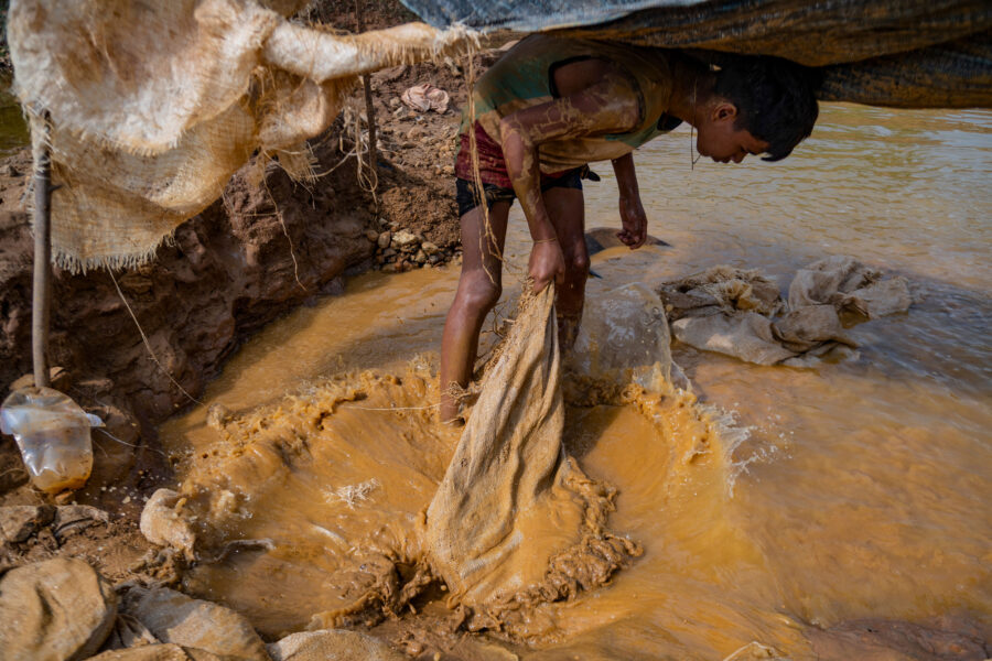 A young Venezuelan miner works in an open pit mine in search of gold in El Callao, Venezuela, on Aug. 29, 2023. Credit: Magda Gibelli/AFP via Getty Images