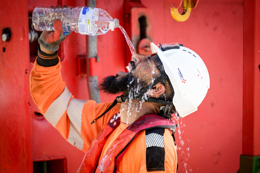 A construction worker cools off with water as a heatwave hits France in Nantes on June 19, 2025. Credit: Loic Venance/AFP via Getty Images