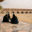 Women sit on a sidewalk along the dried-up riverbed of the Zayanderud in Isfahan, Iran, on Dec. 1, 2025. Credit: Hozi/Middle East Images/AFP via Getty Images