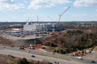 Cars pass a data center under construction in Ashburn, Va., on Nov, 12, 2025. Credit: Andrew Caballero-Reynolds/AFP via Getty Images