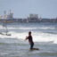A fisherman casts a net into the sea as an oil tanker is seen anchored in the background on Dec. 18, 2025, in Puerto Cabello, Venezuela. Credit: Jesus Vargas/Getty Images