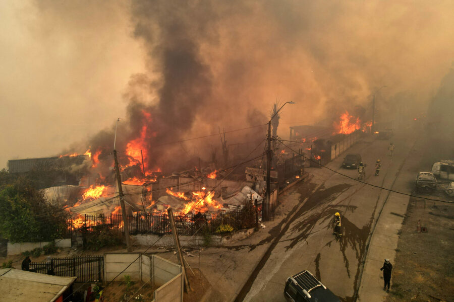 An aerial view of burning houses as a wildfire blazes through Concepción, Chile, on Jan. 18. Credit: Guillermo Salgado/AFP via Getty Images
