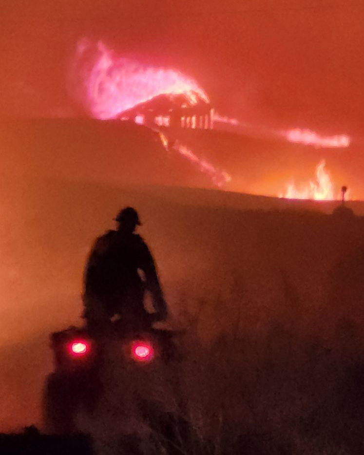 Jacob McCarthy, who spent weeks fighting fires in northeastern Wyoming during the summer of 2024, rides an ATV while combatting the Badger Fire. Credit: Courtesy of Jacob McCarthy
