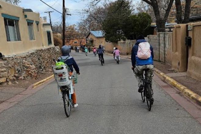Children are chaperoned by teachers on a bike bus in Santa Fe, N.M. Credit: Ryan Harris