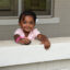 Amber DeLoney-Stewart’s 2-year-old daughter Valencia stands in front of their former home in East Trenton, N.J. Credit: Anna Mattson/Inside Climate News