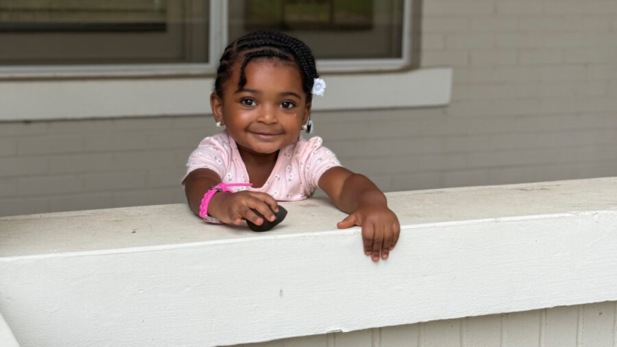 Amber DeLoney-Stewart’s 2-year-old daughter Valencia stands in front of their former home in East Trenton, N.J. Credit: Anna Mattson/Inside Climate News