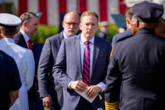 EPA Administrator Lee Zeldin (C) and Office of Management and Budget Director Russell Vought (L), the architects of the Trump administration's climate and environmental justice grant terminations, at a 911 ceremony in Arlington, Virginia. Credit: Andrew Harnik/Getty Images