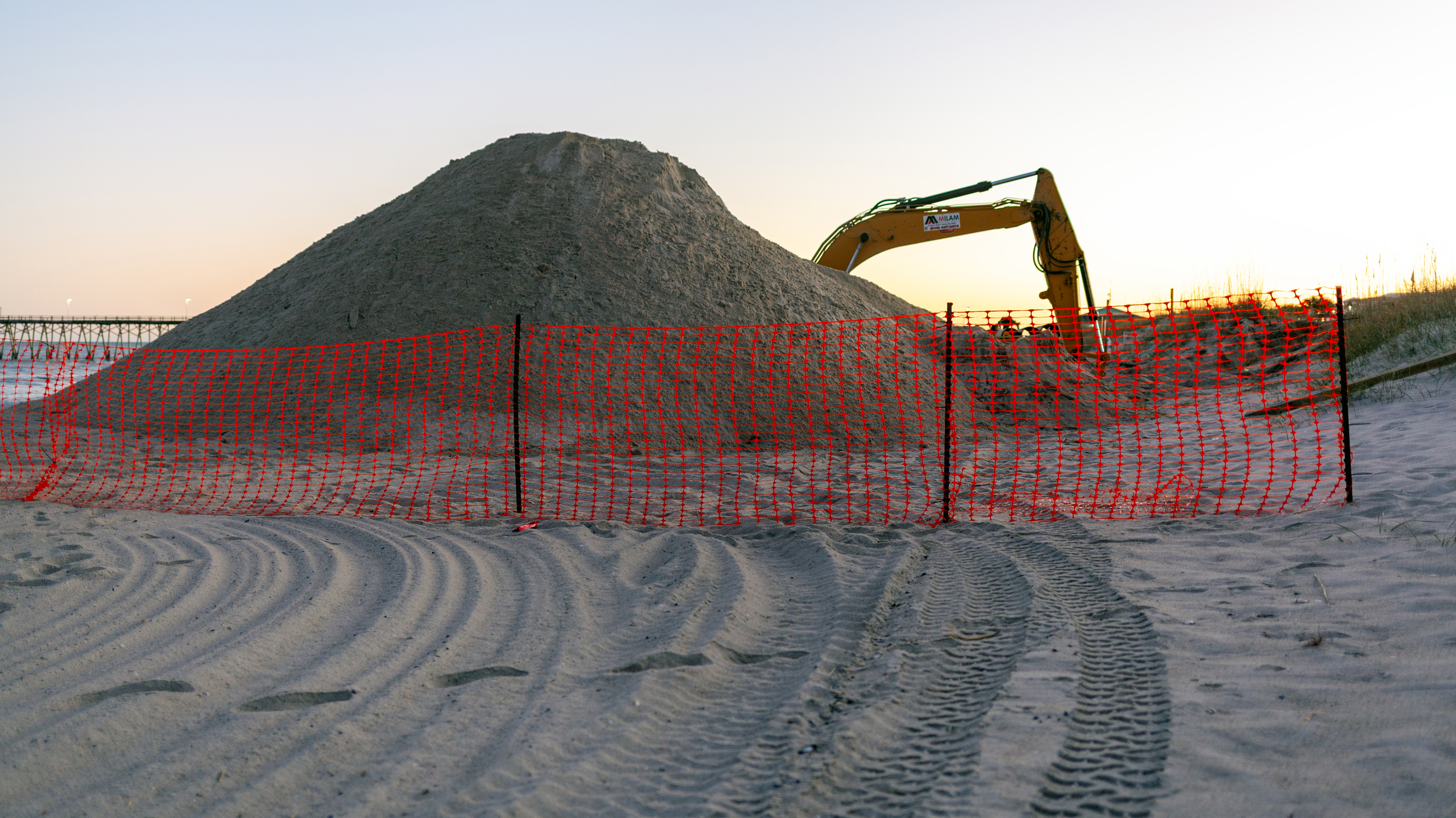 Sand is placed on beaches as part of routine maintenance, but there is no legal requirement to test the material for PFAS, even in areas known to be contaminated. Credit: Lisa Sorg/ Inside Climate News