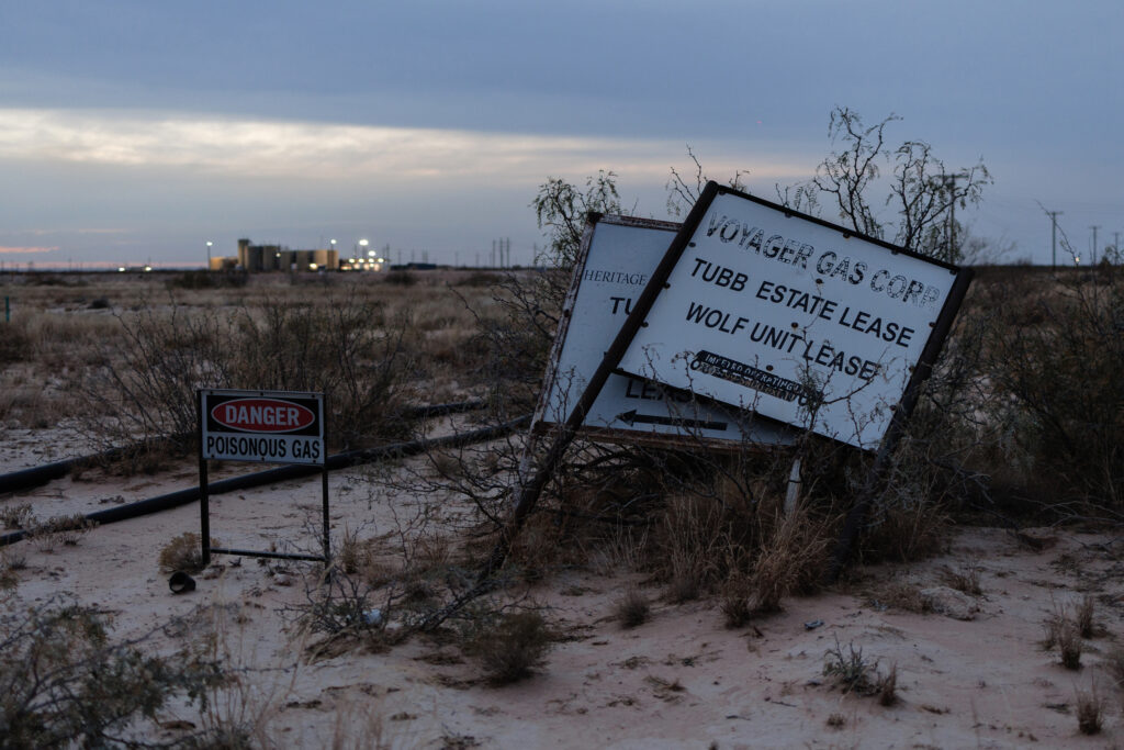 An old sign for Heritage Standard leans by the side of Frying Pan Ranch Road in Winkler County, Texas, on Nov. 19, 2025. The company went bankrupt and left groundwater contamination at the T-Bar Ranch. Credit: Paul Ratje/Inside Climate News