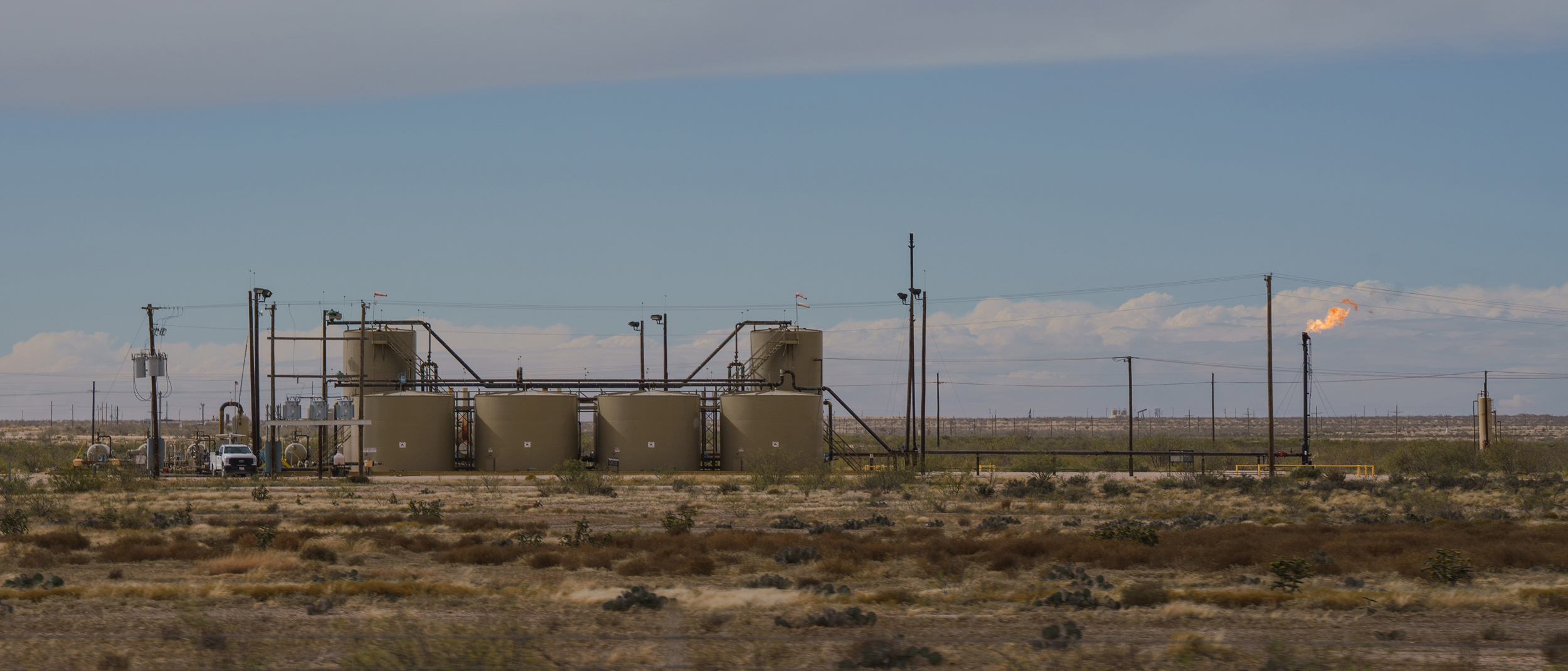 An oil and gas tank battery and flare are seen on the outskirts of Midland, Texas. Credit: Paul Ratje/Inside Climate News