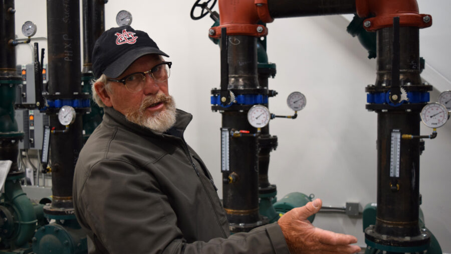 Bill Slaughter, the heating, ventilation and air conditioning technician at Colorado Mesa University, maintains the daily operations of the school’s geothermal network. Credit: Phil McKenna/Inside Climate News