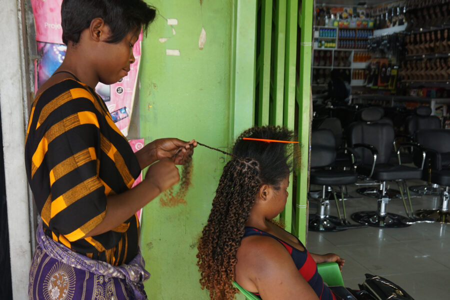 A hairdresser braids a client’s hair with synthetic hair extensions in Lusaka, Zambia, on Aug. 15, 2023. Credit: Lillian Banda/Xinhua via Getty Images