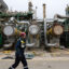 An employee walks on a platform at TotalEnergies’ La Mède refinery near Marseille, France. Credit: Miguel Medina/AFP via Getty Images