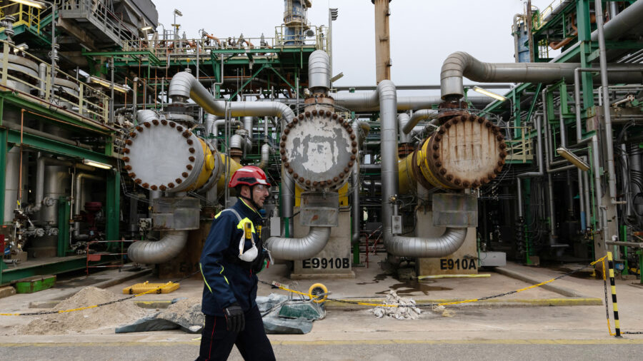 An employee walks on a platform at TotalEnergies’ La Mède refinery near Marseille, France. Credit: Miguel Medina/AFP via Getty Images