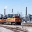 A coal fuel supply train sits adjacent to the stacks of the coal-fired units at the W.A. Parish Generating Station in Richmond, Texas. Credit: Kirk Sides/Houston Chronicle via Getty Images