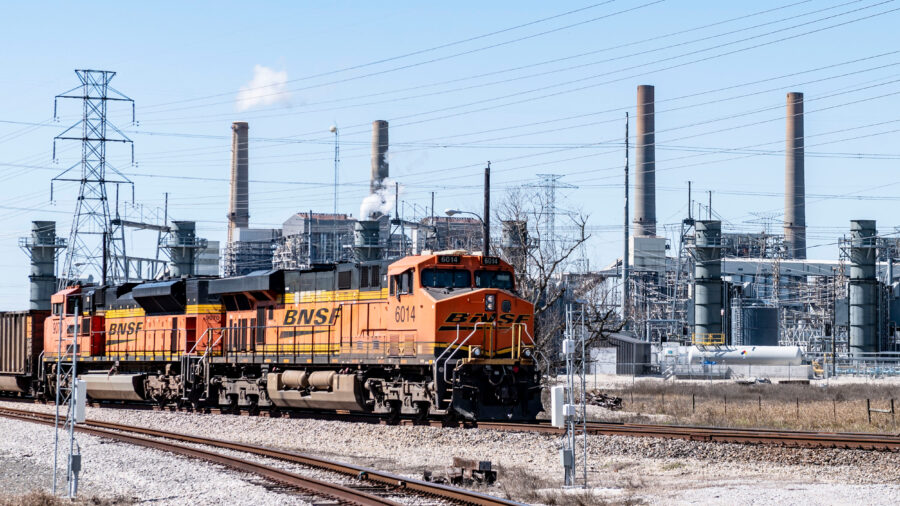 A coal fuel supply train sits adjacent to the stacks of the coal-fired units at the W.A. Parish Generating Station in Richmond, Texas. Credit: Kirk Sides/Houston Chronicle via Getty Images