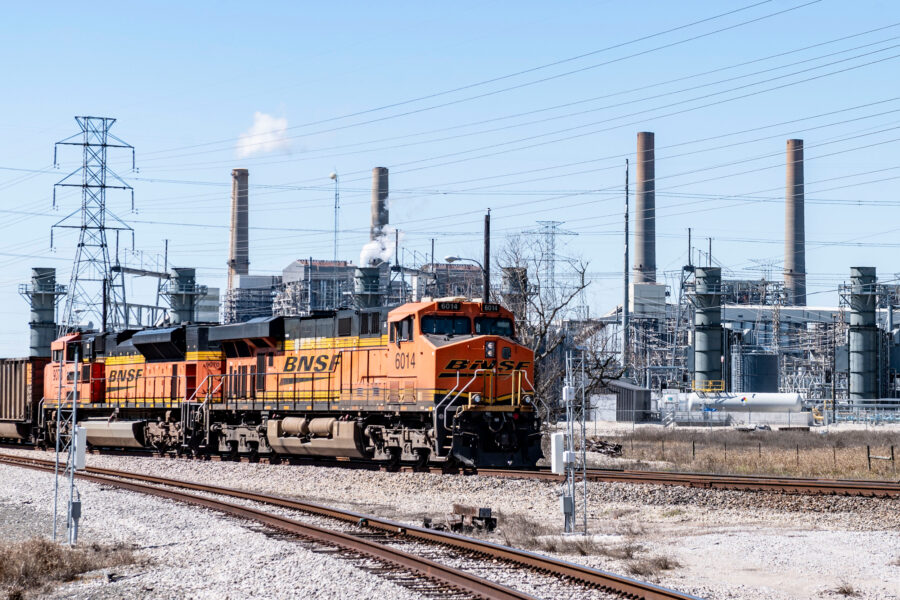 A coal fuel supply train sits adjacent to the stacks of the coal-fired units at the W.A. Parish Generating Station in Richmond, Texas. Credit: Kirk Sides/Houston Chronicle via Getty Images
