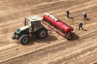 Farmers use a self-driving tractor to sow wheat on a farm in Zhangye, China. Credit: CFOTO/Future Publishing via Getty Images