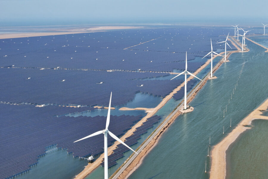 Solar panels and wind turbines are seen at the Huaneng Binzhou new energy power generation project in Binzhou, China, on June 11, 2025. Credit: STR/AFP via Getty Images