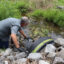 Water quality expert Bob Bowcock tests a creek for cancer-causing PFAS “forever chemicals” at a property in Dalton, Ga., on June 12, 2025. Credit: Issam Ahmed/AFP via Getty Images