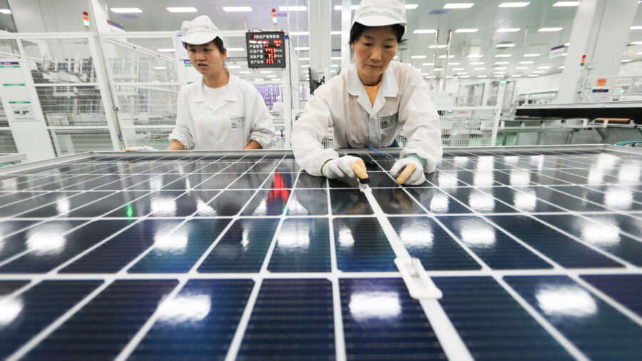 Employees work on photovoltaic cell modules used in solar panels at a factory in Lianyungang, China. Credit: AFP via Getty Images