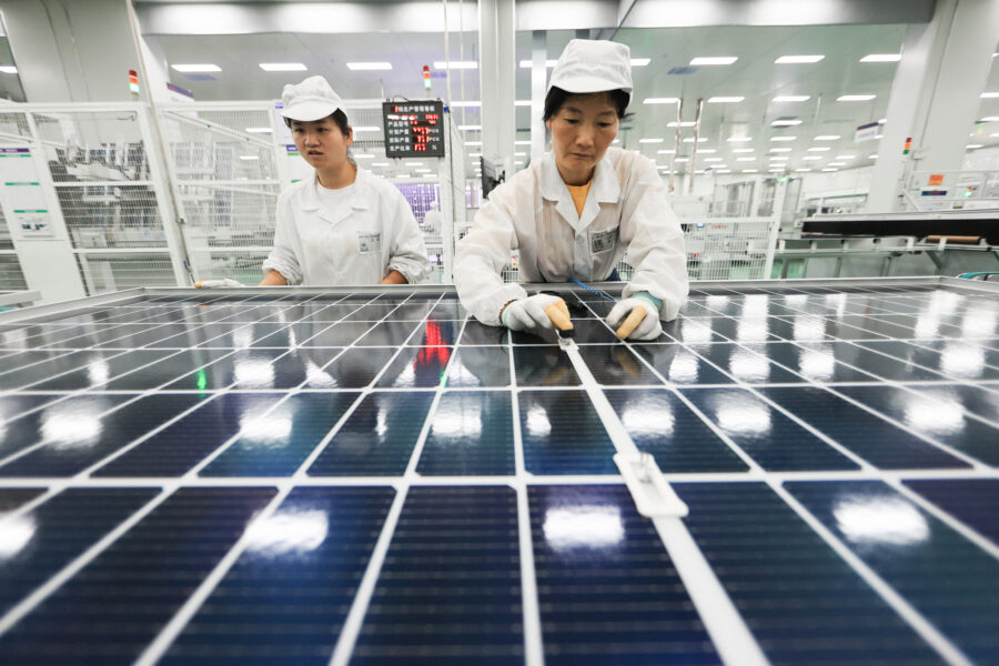 Employees work on photovoltaic cell modules used in solar panels at a factory in Lianyungang, China. Credit: AFP via Getty Images