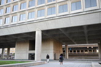 Employees walk into the U.S. Department of Energy building in Washington, D.C. Credit: Andrew Caballero-Reynolds/AFP via Getty Images