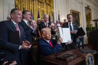 The photo in the White House shows other administration officials and coal miners.