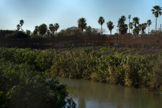 The Rio Grande and the border wall are seen in Brownsville, Texas, on Jan. 15. Credit: Gabriel V. Cardenas/AFP via Getty Images