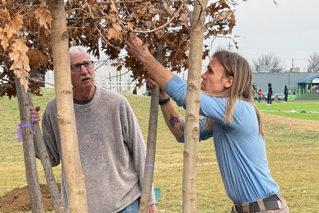 TreesLouisville staffers Mike Hayman (left) and Jake Ackley inspect oak tree sources from either Arkansas or Georgia before planting them in Louisville, Ky. Credit: James Bruggers/Inside Climate News