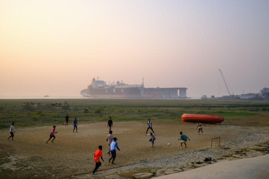 Local teenagers play soccer in front of the Sitakunda ship graveyard. Credit: Spencer Call/NGO Shipbreaking Platform.