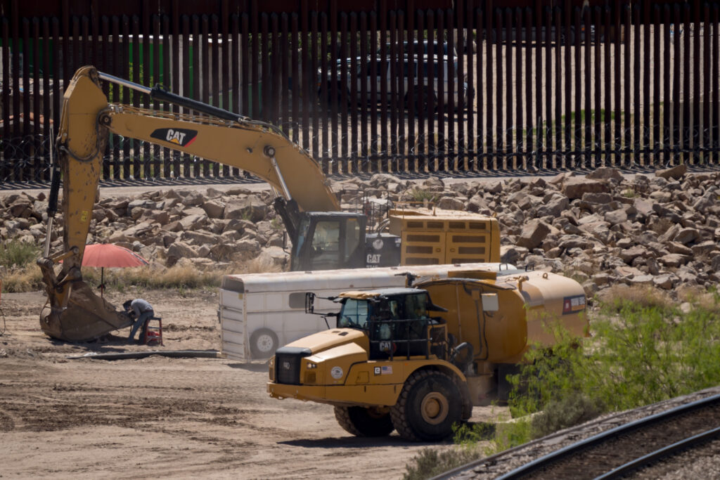 Construction crews operate heavy equipment along the U.S.-Mexico border wall near Sunland Park, New Mexico, on March 24, 2026.
