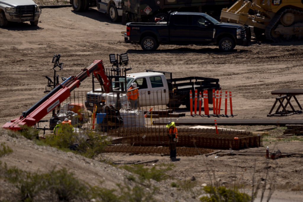 Construction workers prepare materials along the U.S.-Mexico border wall near Sunland Park, New Mexico, on March 24, 2026.