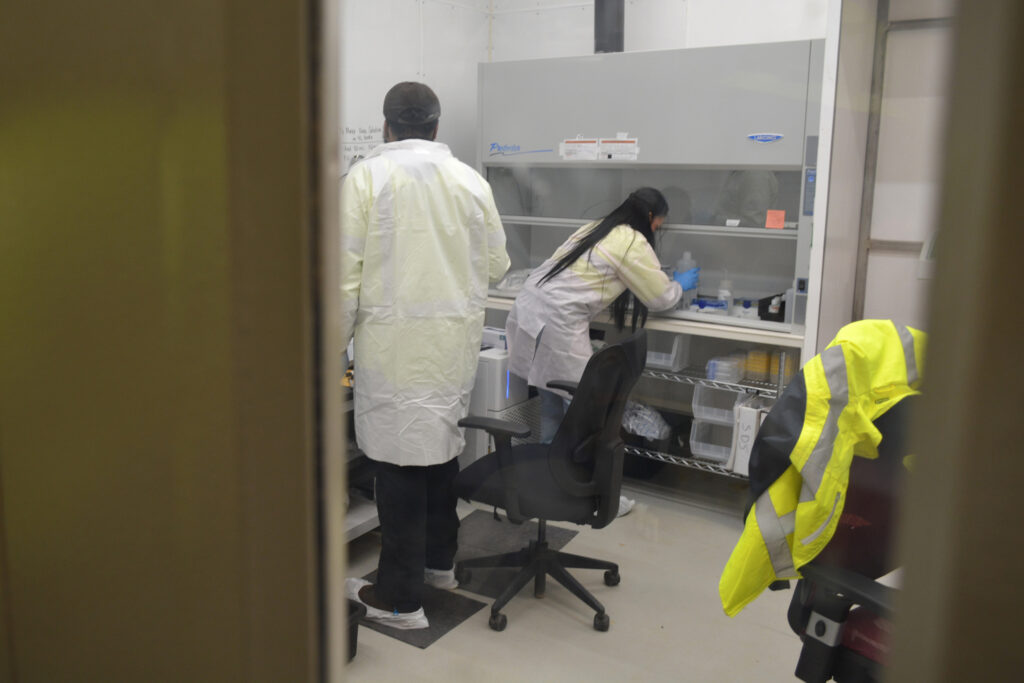 Lab workers take samples of wastewater from the South32’s Hermosa wastewater treatment facility. Before mining can begin, the aquifer must be dewatered. But that water is naturally contaminated with minerals and must be treated before being discharged into a local creek. Credit: Wyatt Myskow/Inside Climate News
