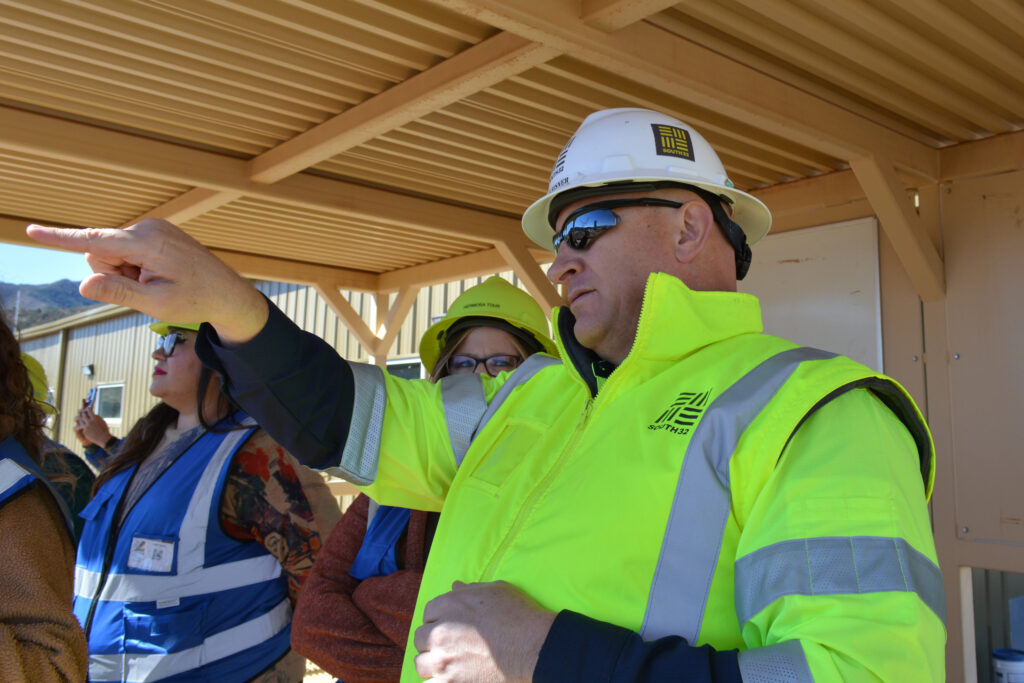Pat Risner points to the mine’s shafts currently under construction during a media tour of the site on Feb. 18. Credit: Wyatt Myskow/Inside Climate News