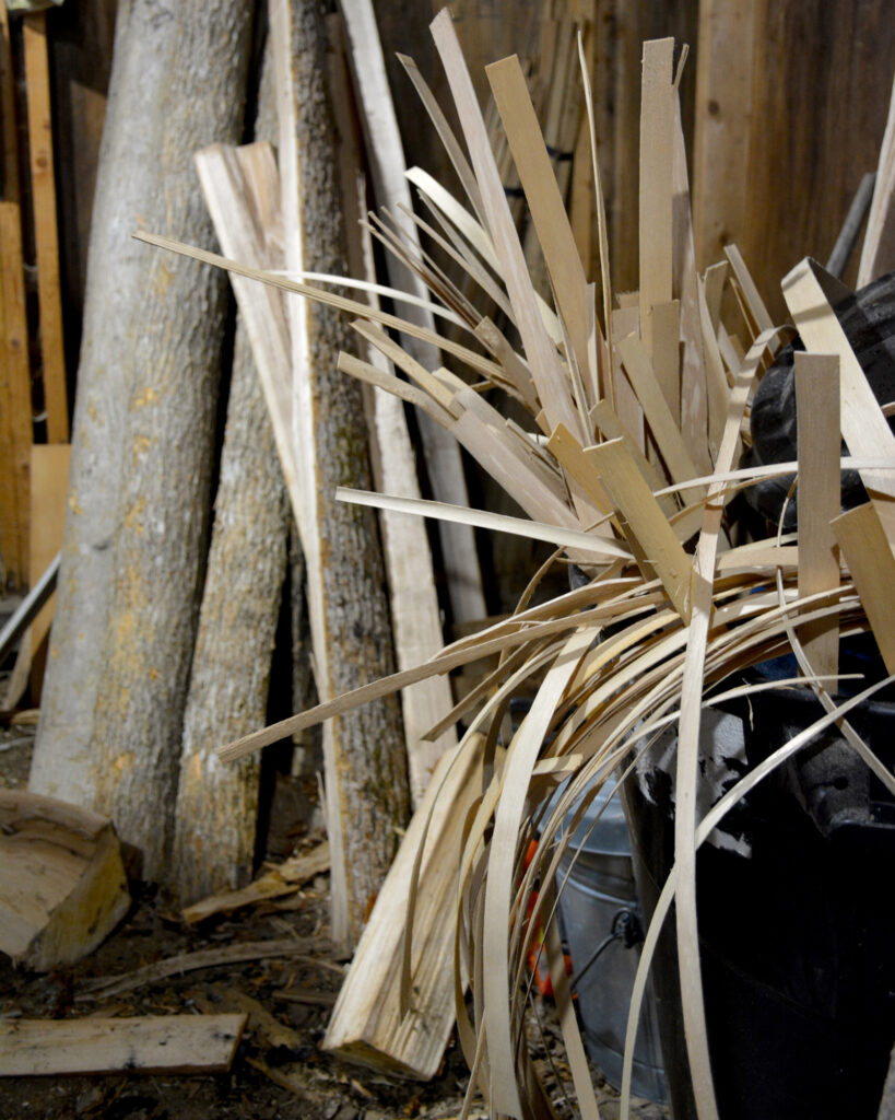 Ash logs and splints of prepared wood in Richard Silliboy’s basketmaking workshop in Littleton, Maine. Credit: Sydney Cromwell/Inside Climate News