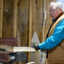 Richard Silliboy uses a machine to pound an ash log in his workshop. Once pounded, the log will divide into layers that can be separated and thinned into strips for basketmaking. Credit: Sydney Cromwell/Inside Climate News